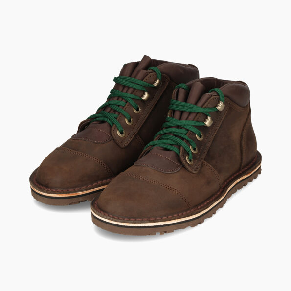 Brown leather boots with green laces on a white background
