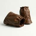 Two brown leather gaiters on a white background